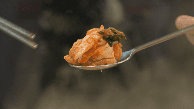 Kimchi and chicken on spoon