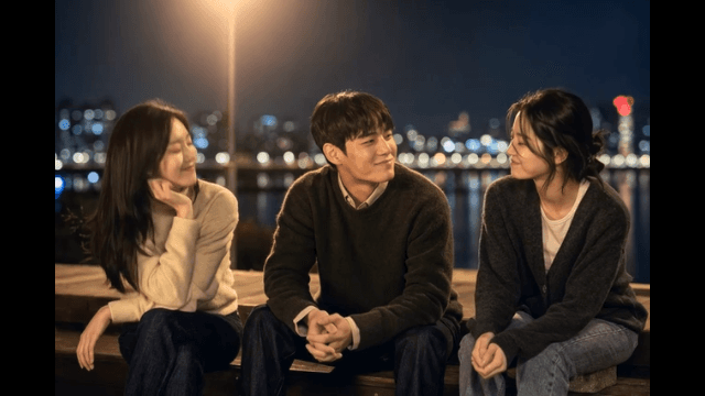 Friends talking by the river at night