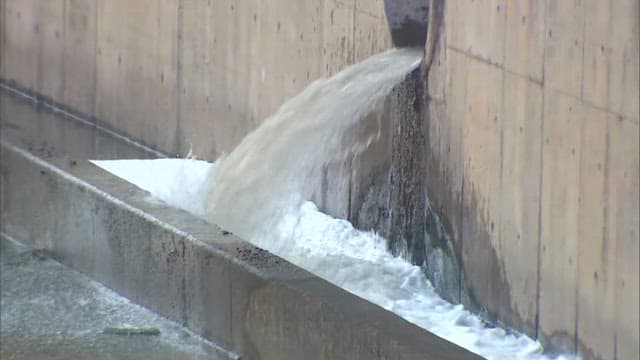 Water exiting from drain in concrete wall
