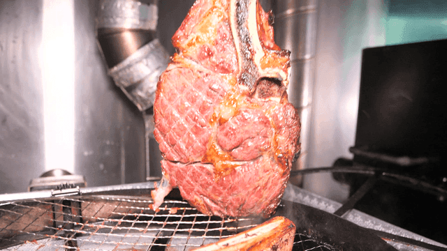 Grilled Tomahawk Steak on Metal Grill