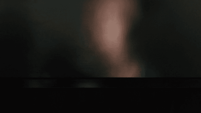 Blurred silhouette of person behind opaque glass