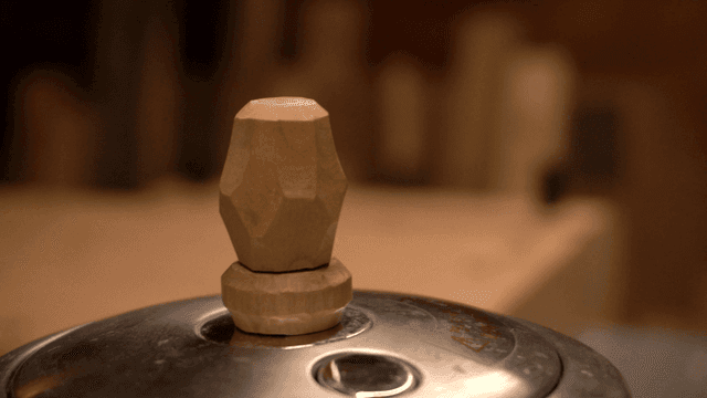 Unique handcrafted wooden handle on metal lid