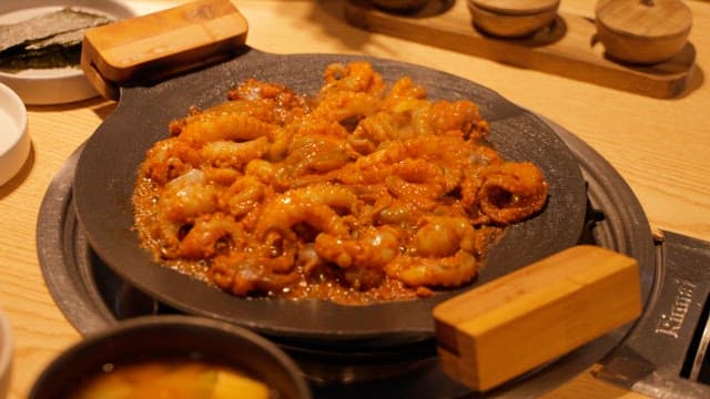 Spicy Stir-Fried Octopus Eaten at a Restaurant