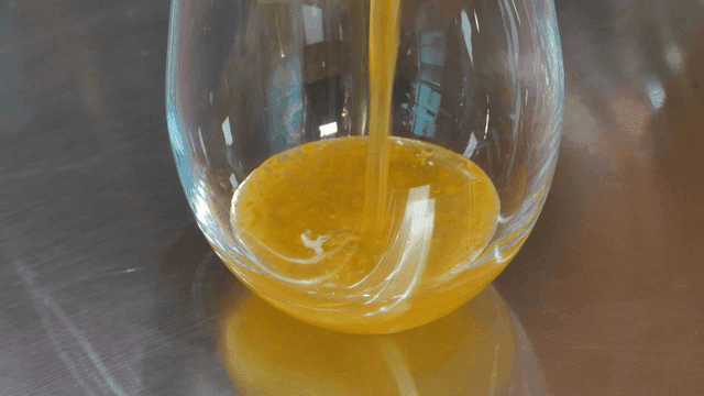 Orange juice being poured into a glass