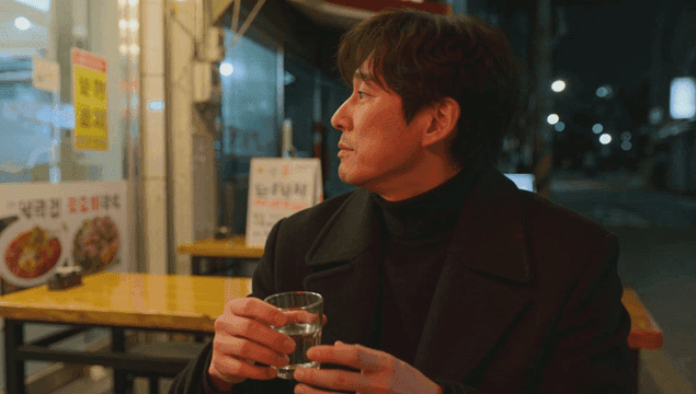 Man drinking alone at a street restaurant
