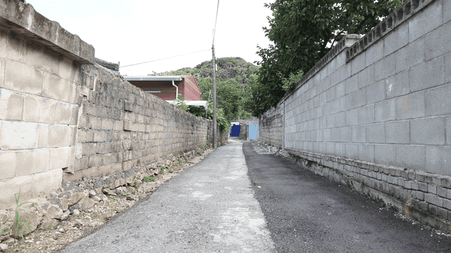 Narrow alley between brick walls