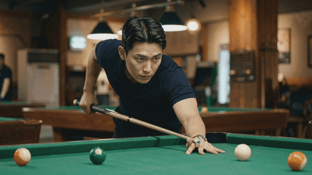 Man concentrating on billiards shot