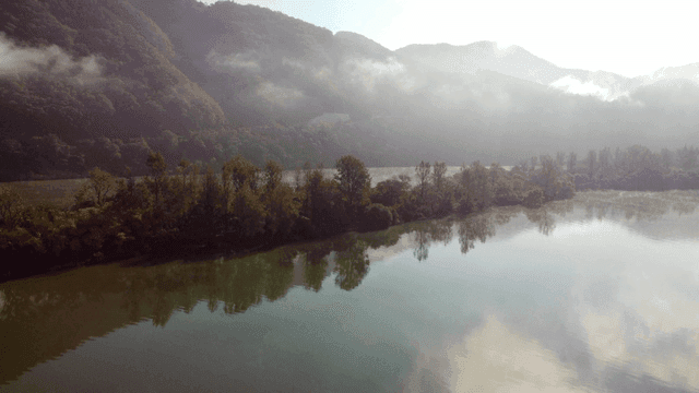 Foggy river with mountains in background