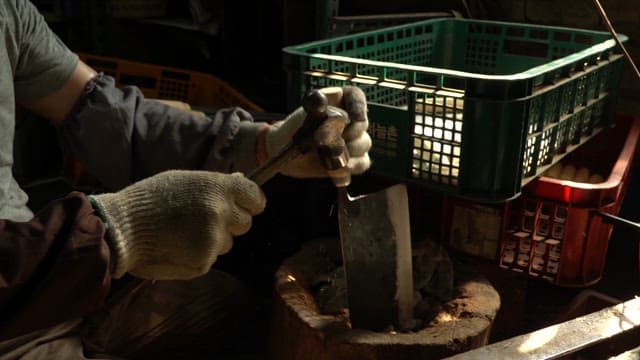 Craftsman sharpening a large knife