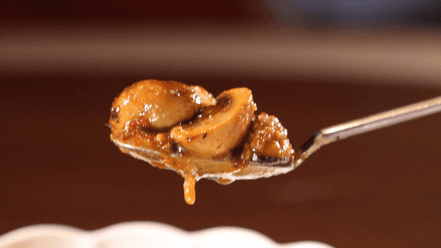 Delicious mushroom dish with sauce on spoon