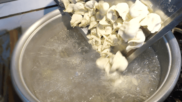 Dumplings being added to boiling water