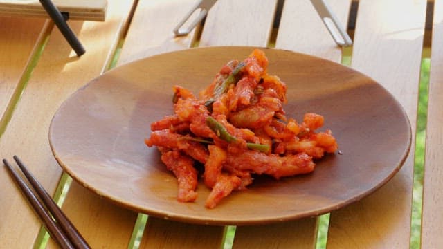 Radish kimchi plated on a wooden plate