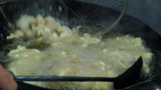 Frying pork in hot oil