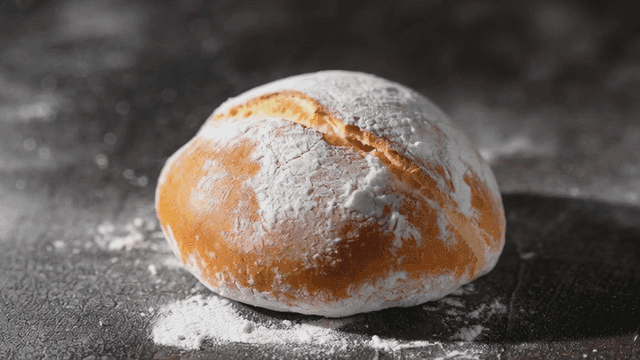 Freshly baked bread on a floured surface