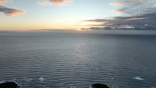 Sunset over a calm ocean horizon