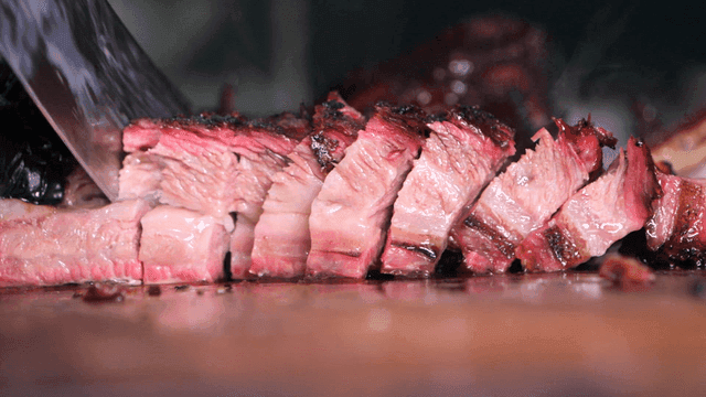 Juicy slices of grilled meat on a board