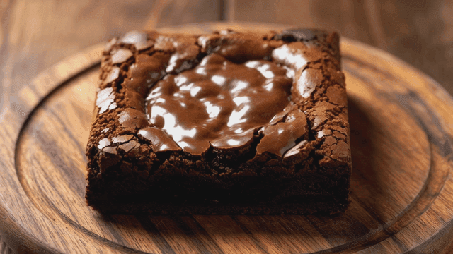 Rich chocolate brownie on wooden plate