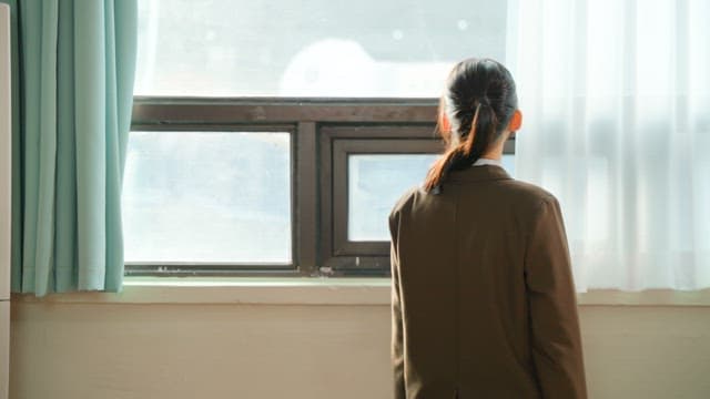 Student looking out the classroom window