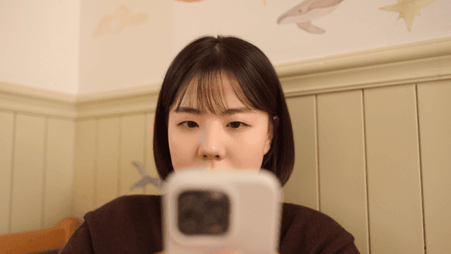 Young woman concentrating on her smartphone and smiling