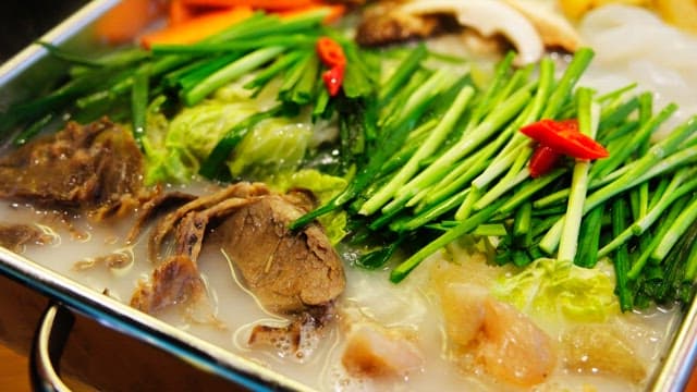 Boiling tendon hotpot with vegetables and meat in a pot