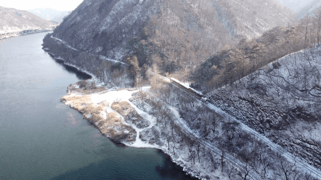 Train running through snow-covered mountain