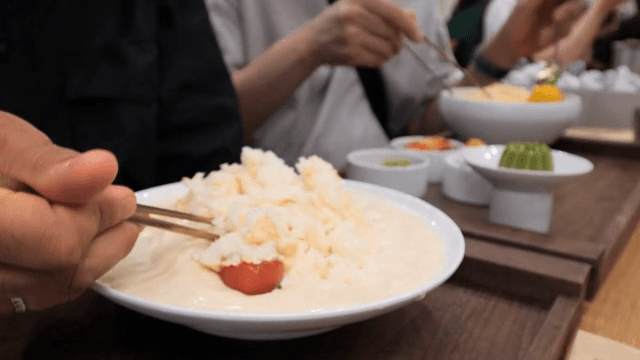 People enjoying noodles in cold soybean soup