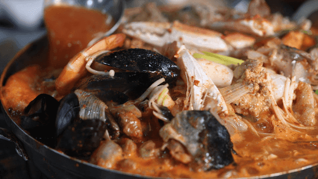 Sight of spicy anglerfish seafood stew boiling