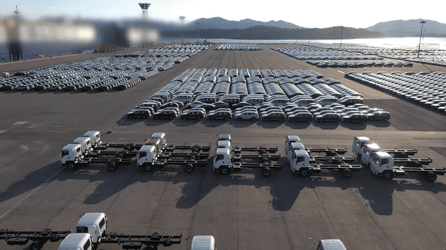 Large shipping parking lot filled with vehicles