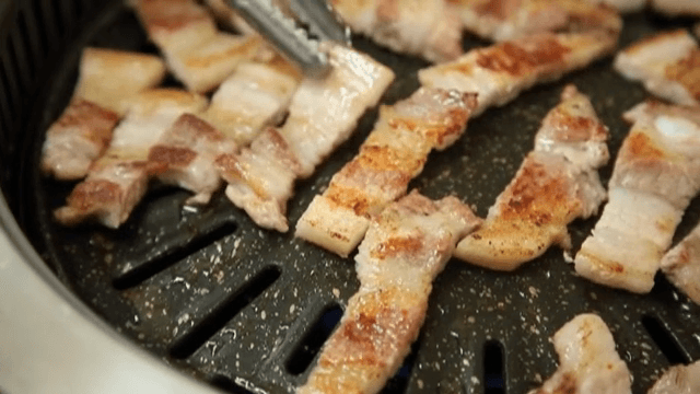 Grilling Grilled Pork Belly slices on a hot pan