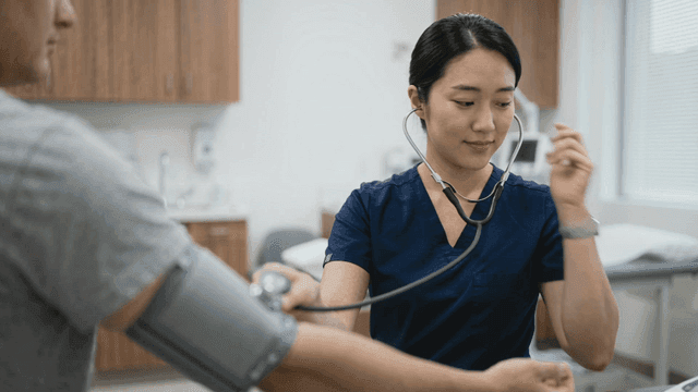 Nurse checking a patient's blood pressure