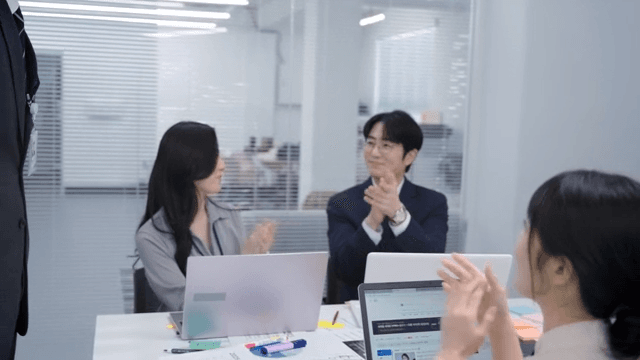 Employees clapping and celebrating in the meeting room