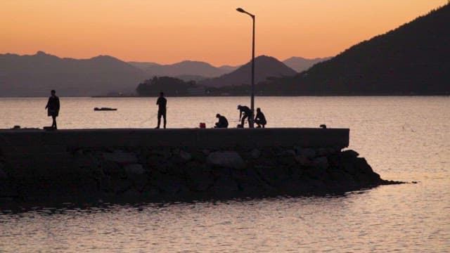 People Fishing on the Coast of Suncheon Sea at Sunset