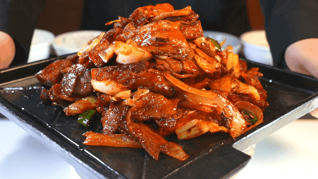 Spicy stir-fried pork being served
