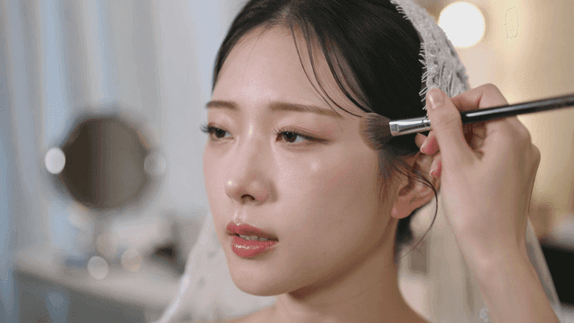 Bride getting her makeup done at makeup shop