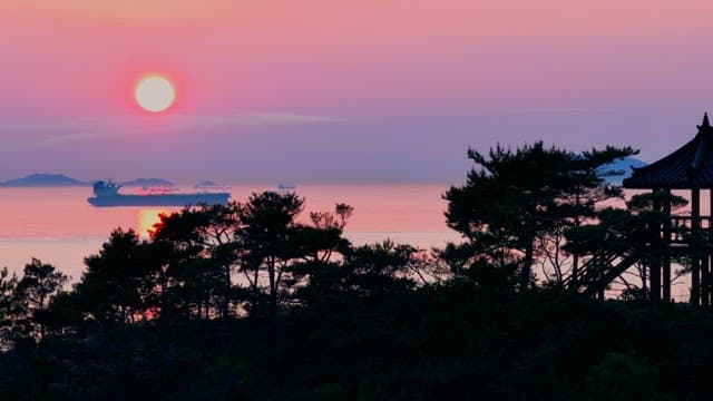 Tranquil Sunset Seen from a Pavilion on a Coastal Hill