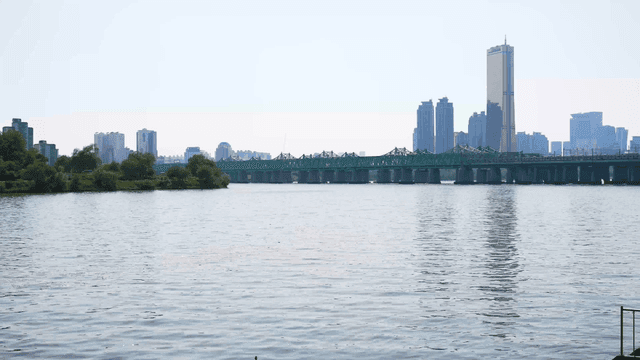A river with a city skyline and bridge