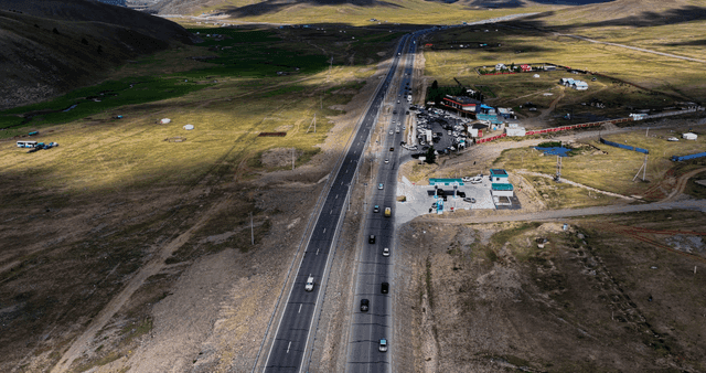 A highway cutting through vast open fields