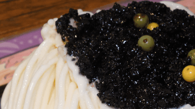 Shaved ice topped with black crumbs