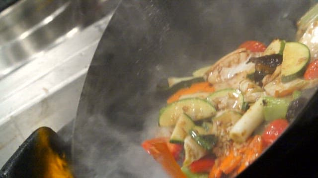 Vegetables being stir-fried in a wok