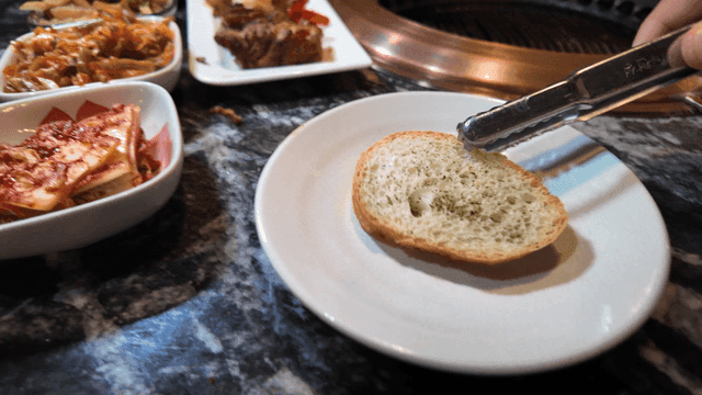 Variety of dishes and baguette bread on table