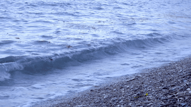 Waves gently crashing on a pebble beach