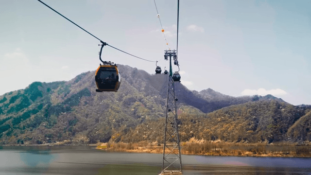 Cable cars over a scenic mountain lake