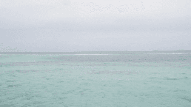 Calm sea with gentle waves under a cloudy sky