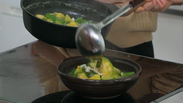 Pumpkin soup dish served generously in a black bowl