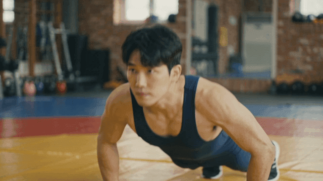 Man doing push-ups at gym with concentration