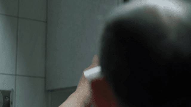 Man taking sanitary pad out of bathroom cabinet