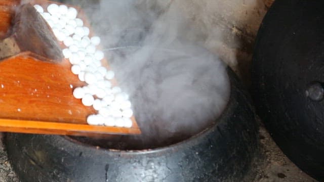 Making Red Bean Porridge with Rice Balls in a Steaming Cauldron