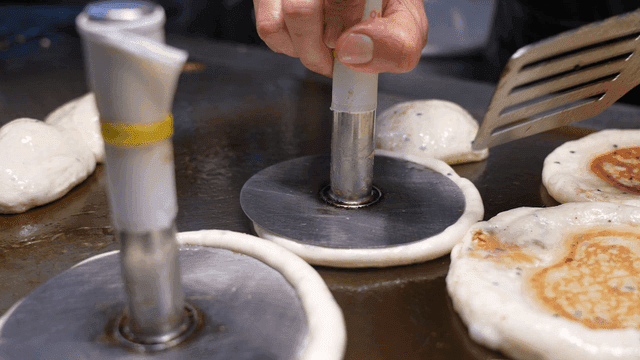 Hotteok cooked on hot iron plate