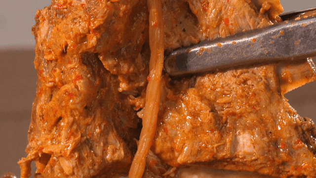 Pork backbone stew topped with sweet potato stems