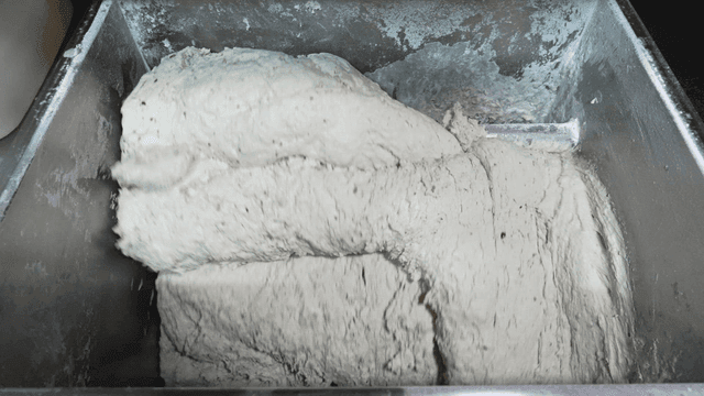Dough being mixed in a large industrial mixer